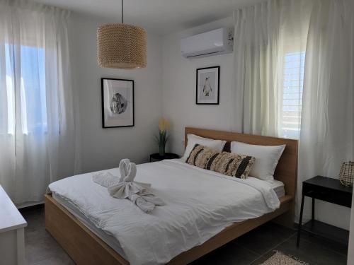 a bedroom with a bed with a bow on it at view point relax in Eilat