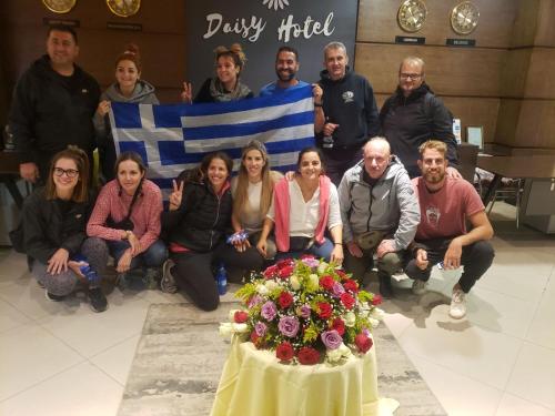 a group of people sitting around a table with a flag at Daisy Hotel in Addis Ababa