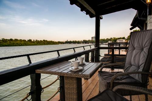 a table on the deck of a boat on the water at Bahus Inn in Belgrade