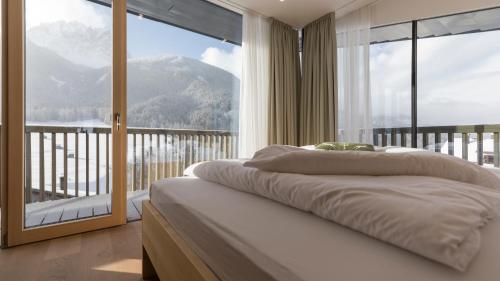 a bedroom with a bed with a view of a mountain at Villa Rainer in Sesto