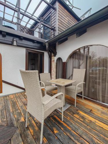a patio with chairs and a table on a deck at Bahus Inn in Belgrade