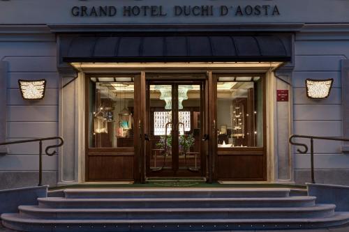 a front door of a grand hotel with stairs in front at Grand Hotel Duchi d'Aosta in Trieste
