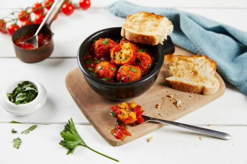 a bowl of food on a cutting board with bread at Holiday Inn - Leicester - Wigston by IHG in Leicester