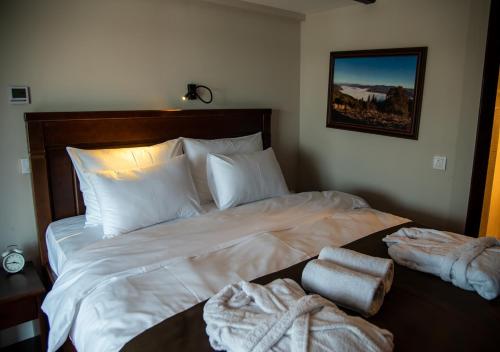 a bedroom with a large bed with towels on it at Bahus Inn in Belgrade
