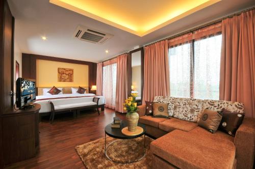 a living room with a couch and a bed at Salana Boutique Hotel in Vientiane
