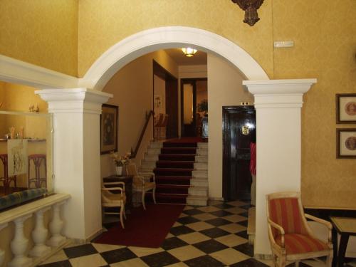 a hallway with an archway and stairs in a house at Cavalieri Hotel in Corfu Town