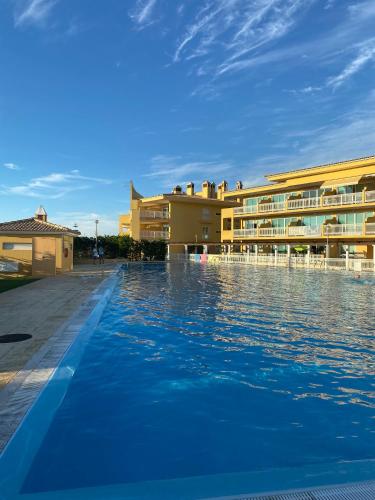 a swimming pool in front of a hotel at Santa Lovers in Santa Cruz