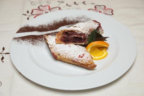 a white plate with a piece of food on it at Hotel Zagi in Oroslavje