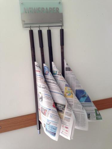 a bunch of newspapers hanging on a refrigerator at Hotel Vittoria in San Giovanni Rotondo