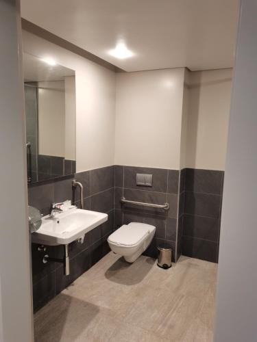 a bathroom with a toilet and a sink at City Lodge Hotel Maputo, Mozambique in Maputo