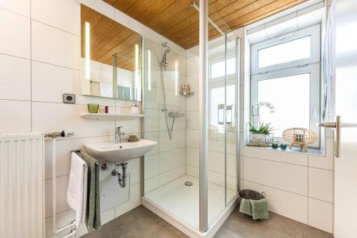 a bathroom with a glass shower and a sink at Ratskeller Lauda in Lauda-Königshofen