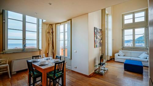 a living room with a table and chairs and a couch at Virgilio 2 - Villa Bice in Alassio