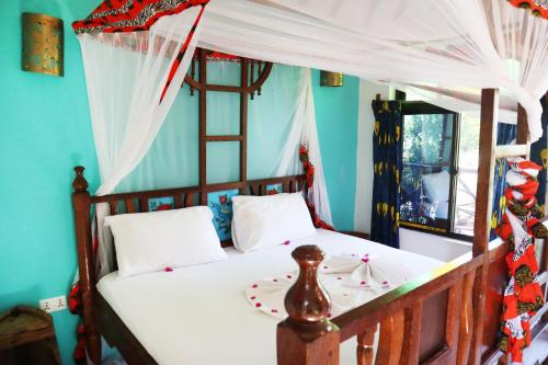 Postel nebo postele na pokoji v ubytování Sagando Bungalows Zanzibar