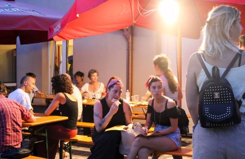 a group of people sitting at tables in a restaurant at Ostello La Salana in Capannori