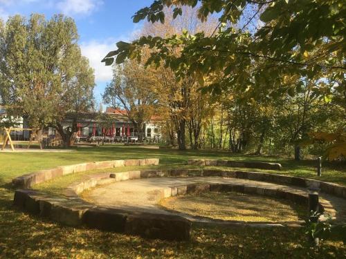 a park with a pond in the grass at Hotel Müllers-Weiden in Eschwege