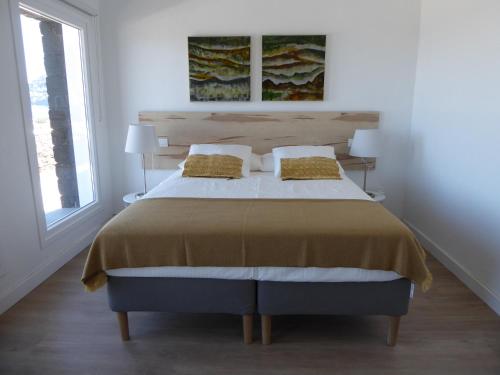 a bedroom with a large bed with two pillows at Villa Gallotia in Las Puntas