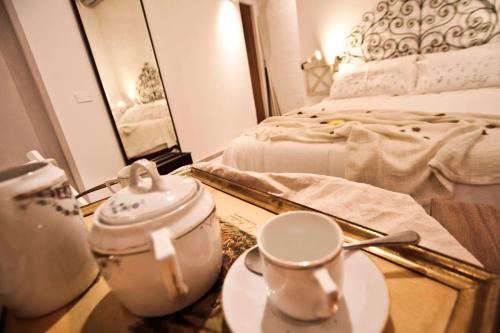a bedroom with a bed and a table with a tea set at SottosopraSannio in Rome