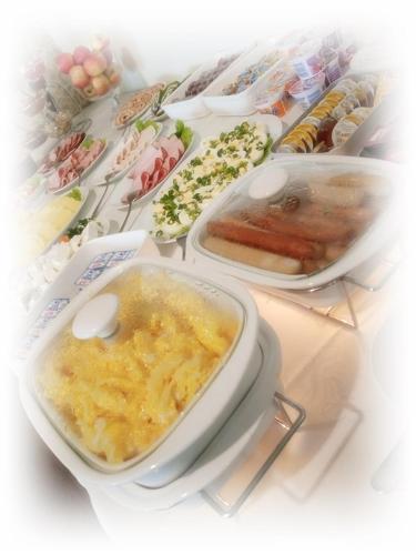 a table topped with bowls of soup and other foods at Hotel TiM in Cekanowo
