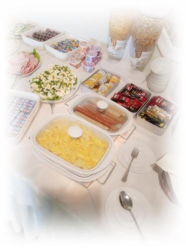 a table topped with different types of food at Hotel TiM in Cekanowo