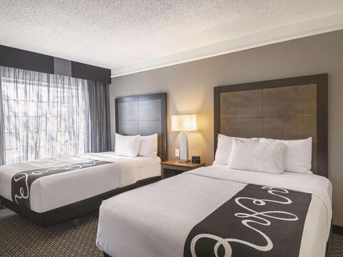 a hotel room with two beds and a window at La Quinta by Wyndham Austin at The Domain in Austin