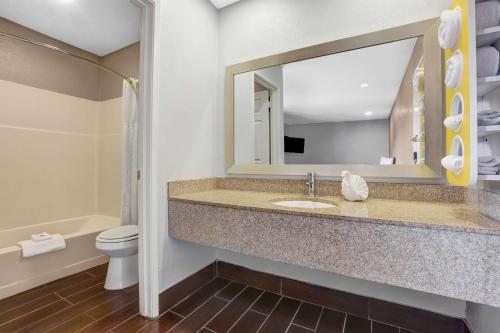 a bathroom with a sink and a toilet and a mirror at Motel 6-Ukiah, CA - North in Ukiah