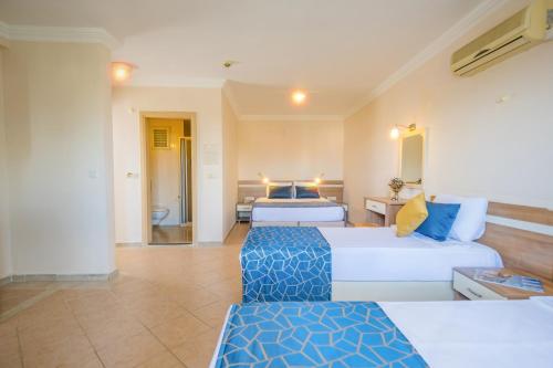 a living room with two beds and a couch at Catty Cats Garden Hotel in Side