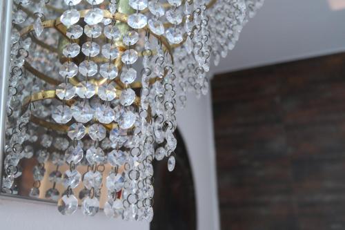 a chandelier with crystals hanging from it at Hotel Villa Reale in Noventa Padovana