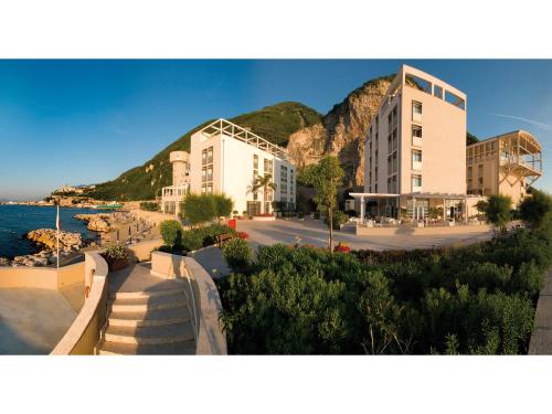 a group of buildings next to a body of water at Towers Hotel Stabiae Sorrento Coast in Castellammare di Stabia