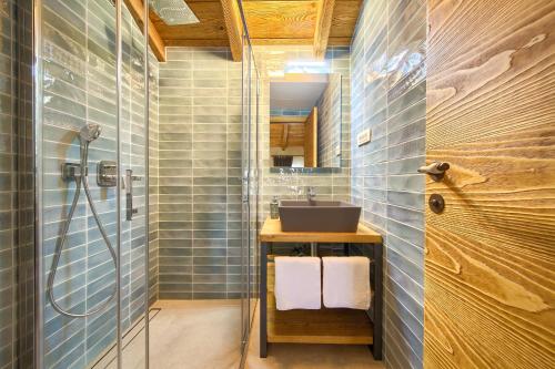 a bathroom with a shower and a sink at Luxury Jerini House with pool and wellness in Bajčići