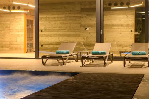 two chairs and a coffee table in a lobby at Luxury Jerini House with pool and wellness in Bajčići