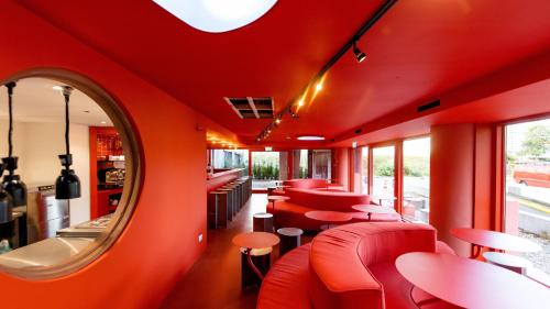 a dining room with red walls and a red ceiling at Hotel Not Hotel Rotterdam in Rotterdam