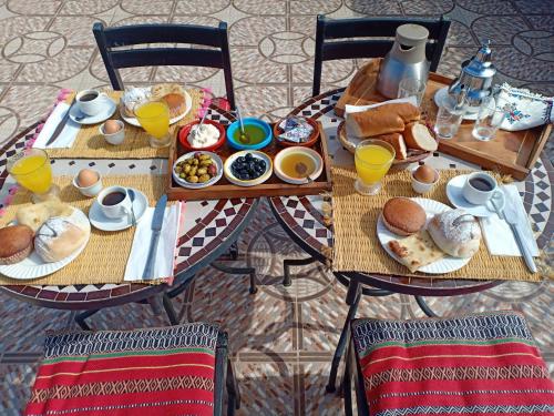 a table with breakfast foods and drinks on it at Dar HAJAR in Marrakech