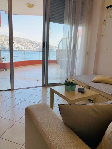 a living room with a couch and a coffee table at Saranda Port View Apartments in Sarandë