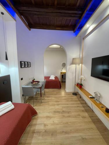 a hotel room with a bed and a television at Elian Apartament In The Center of Rome in Rome