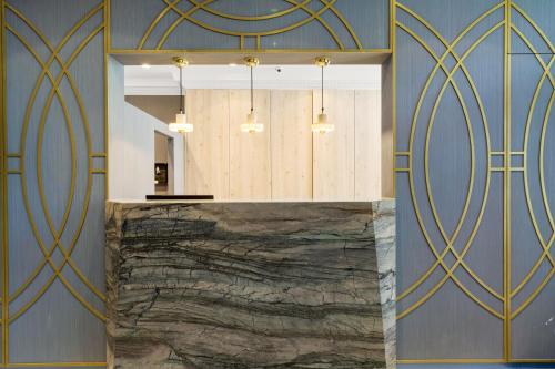 a kitchen with blue walls and gold accents at Commodore Hotel in London