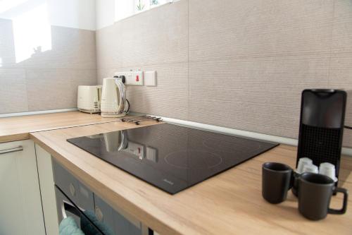 a kitchen with a sink and a counter top at Tikay Holiday Apts in Ayia Napa