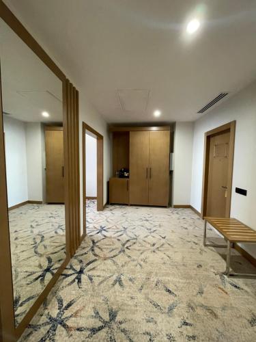 an empty room with a table and a bench at Farovon Khiva Hotel in Khiva