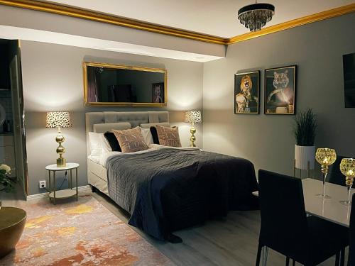 a bedroom with a bed and a mirror on the wall at Killeröd Boutique Apartments in Båstad