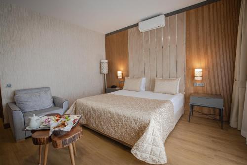 a hotel room with a bed and a chair at bahçelievler hotels in Ankara