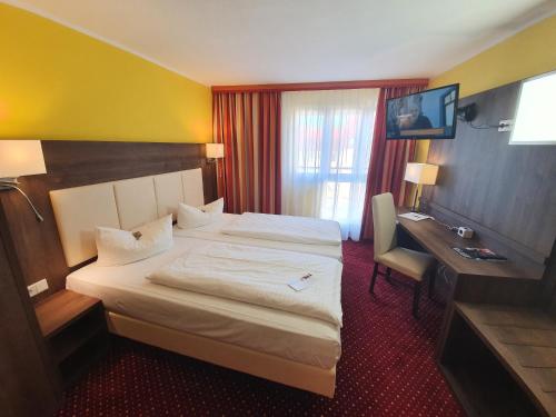 Postel nebo postele na pokoji v ubytování INVITE Hotel Nürnberg City