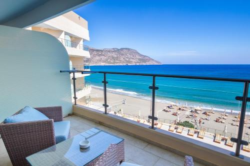 a balcony with a view of the beach at Konstantinos Palace in Karpathos Town