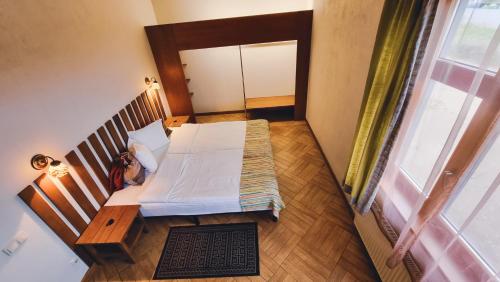 a room with a bed and a table and a window at Kapteinu Osta in Salacgrīva