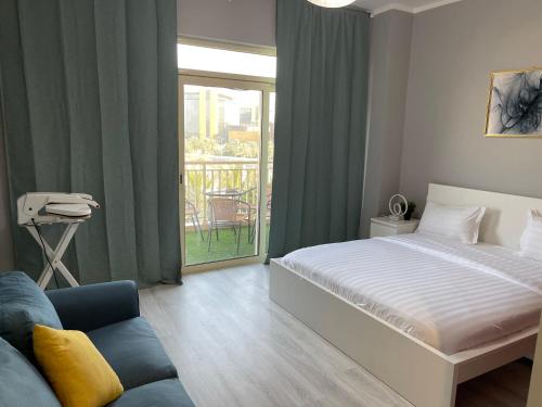 a bedroom with a bed and a couch and a window at موج البحر ابراج الشاطئ مدينه الملك عبدالله الاقتصاديه عوائل فقط in King Abdullah Economic City