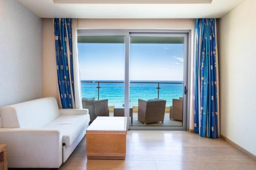 a living room with a view of the ocean at Konstantinos Palace in Karpathos Town