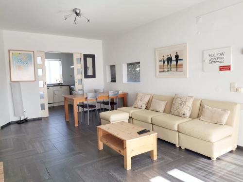 a living room with a couch and a table at Unique Apartment Milfontes - Duna Parque Group in Vila Nova de Milfontes