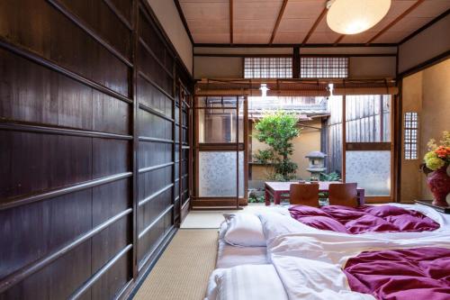 Postel nebo postele na pokoji v ubytování お宿梅夜Guesthouse Umeya