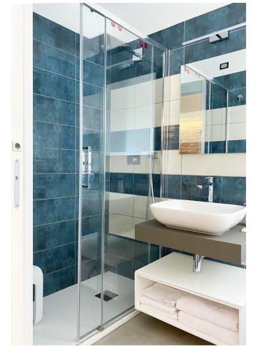 a bathroom with a sink and a glass shower at Naturamare B&B in Villapiana