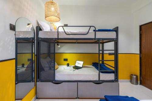 two bunk beds in a room with a laptop at Coliwo Un - Viman Nagar in Pune