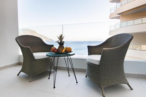 two chairs and a table with a pineapple on it at Konstantinos Palace in Karpathos Town