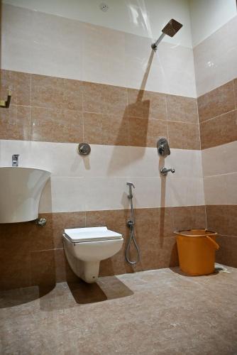 a bathroom with a toilet and a shower at KOZZY B&B in Amritsar